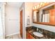 Bathroom with a granite countertop and warm wood cabinetry at 206 Banbury Rd, Noblesville, IN 46062
