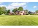 Charming brick home with a well-manicured lawn and mature trees on a sunny day at 206 Banbury Rd, Noblesville, IN 46062