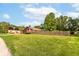 Well-manicured front lawn with a charming home, mature trees, and a classic picket fence at 206 Banbury Rd, Noblesville, IN 46062