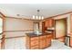 Kitchen island with granite countertops, tile flooring and traditional wood cabinets at 206 Banbury Rd, Noblesville, IN 46062