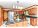 Kitchen with wood cabinets, stainless appliances, and a granite-topped island at 206 Banbury Rd, Noblesville, IN 46062
