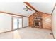 Living room featuring brick fireplace with wood paneling, and access to the exterior at 206 Banbury Rd, Noblesville, IN 46062