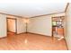 Open living room with wood-look flooring and access to the kitchen at 206 Banbury Rd, Noblesville, IN 46062