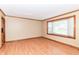 Bright living room featuring a large window and wood-look flooring at 206 Banbury Rd, Noblesville, IN 46062