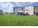 Backyard view with house, green grass and patio at 2101 Shadow Fox Dr, Columbus, IN 47201