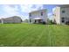 Backyard view with house, green grass and patio at 2101 Shadow Fox Dr, Columbus, IN 47201