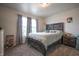 Cozy bedroom with a wooden bed frame, two windows, and gray carpet at 2101 Shadow Fox Dr, Columbus, IN 47201