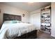 Bedroom featuring a wooden bed, white shelves, and colorful wall decor at 2101 Shadow Fox Dr, Columbus, IN 47201