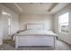 Bedroom features tray ceiling, and natural light from the large window at 2101 Shadow Fox Dr, Columbus, IN 47201