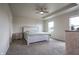 Bedroom featuring a tray ceiling, fan, and natural light from the windows at 2101 Shadow Fox Dr, Columbus, IN 47201