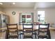 Dining area features a large wooden table with views of the backyard and a stainless steel refrigerator at 2101 Shadow Fox Dr, Columbus, IN 47201