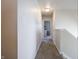 Hallway with neutral walls and gray carpet leading to a bedroom at 2101 Shadow Fox Dr, Columbus, IN 47201