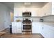 Modern kitchen with stainless steel appliances, laminate countertops, and white cabinetry at 2101 Shadow Fox Dr, Columbus, IN 47201