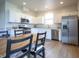 Open concept kitchen featuring stainless steel appliances and an adjacent wood table at 2101 Shadow Fox Dr, Columbus, IN 47201