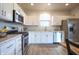 Bright kitchen featuring stainless steel appliances, white cabinets, and laminate countertops at 2101 Shadow Fox Dr, Columbus, IN 47201
