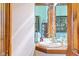 Elegant powder room boasts a wood vanity, decorative mirror, and vintage fixtures for a touch of classic charm at 239 E 11Th St, Indianapolis, IN 46202