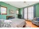Serene bedroom with wood floors, fireplace, and large windows offering natural light and a calming view at 239 E 11Th St, Indianapolis, IN 46202