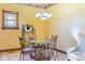 Cozy dining room features a glass table, upholstered chairs, and decorative window with floral accents at 239 E 11Th St, Indianapolis, IN 46202