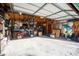 Cluttered two-car garage with ample storage space and overhead lighting at 239 E 11Th St, Indianapolis, IN 46202
