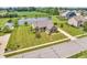 A stunning aerial view showcasing the beautiful home with a pond, pool, and well-maintained lawn at 2948 Chalbury Dr, Plainfield, IN 46168