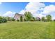 Large backyard with manicured lawn and mature trees bordering neighboring houses at 2948 Chalbury Dr, Plainfield, IN 46168
