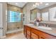 Beautiful bathroom featuring a dual sink vanity and tiled walk-in shower with glass block window at 2948 Chalbury Dr, Plainfield, IN 46168