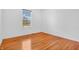 Bedroom showcasing light filled ambiance, neutral walls, hardwood floors, and single window at 2948 Chalbury Dr, Plainfield, IN 46168