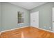 Bedroom featuring hardwood floors, window and double-door closet with white trim at 2948 Chalbury Dr, Plainfield, IN 46168
