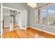 Dining room features hardwood floors, natural light, open glass doors, and neutral wall color at 2948 Chalbury Dr, Plainfield, IN 46168