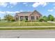 Traditional brick home with a manicured lawn and front yard landscaping at 2948 Chalbury Dr, Plainfield, IN 46168