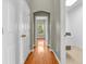 Hallway with wood floors, neutral paint, and access to laundry room at 2948 Chalbury Dr, Plainfield, IN 46168