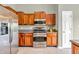 Kitchen with wood cabinets, stainless steel appliances, and tile flooring at 2948 Chalbury Dr, Plainfield, IN 46168