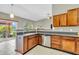 Bright kitchen with wood cabinets, stainless steel appliances, and view of the lake at 2948 Chalbury Dr, Plainfield, IN 46168