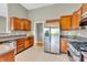 Kitchen features wood cabinets, stainless steel appliances, and tile flooring at 2948 Chalbury Dr, Plainfield, IN 46168