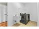 Laundry room featuring a utility sink, washing machine, and dryer at 2948 Chalbury Dr, Plainfield, IN 46168