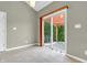 Bright living room with tile flooring, neutral walls, and sliding glass door to the backyard patio at 2948 Chalbury Dr, Plainfield, IN 46168