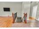Living room with hardwood floors looking towards the staircase, and television at 2948 Chalbury Dr, Plainfield, IN 46168