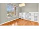 Bright home office space featuring hardwood floors, large window, and installed shelving at 2948 Chalbury Dr, Plainfield, IN 46168