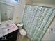 Bathroom features a blue and white shower curtain and a vanity at 3161 Normandy Rd, Indianapolis, IN 46222