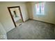 Cozy bedroom featuring soft carpet, a natural light window, and an attached room at 3161 Normandy Rd, Indianapolis, IN 46222
