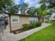 View of the front of the home showcasing a covered porch and neat landscaping at 3161 Normandy Rd, Indianapolis, IN 46222