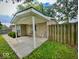A covered porch adds curb appeal to this home featuring tidy landscaping and a wooden privacy fence at 3161 Normandy Rd, Indianapolis, IN 46222
