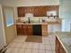 Functional kitchen with classic wood cabinetry and modern black appliances at 3161 Normandy Rd, Indianapolis, IN 46222