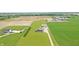 Wide aerial view showcasing a home near large farm fields and farm buildings, surrounded by greenery at 3301 N 200 W, Franklin, IN 46131