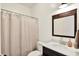 Bathroom features a vanity with mirror and a shower with a curtain; toilet at 3301 N 200 W, Franklin, IN 46131