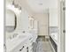 A spacious bathroom has dual vanities, modern lighting, a soaking tub, and decorative tiling at 3301 N 200 W, Franklin, IN 46131