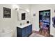 Modern bathroom with a blue vanity, a framed mirror and a view into the walk-in closet at 3301 N 200 W, Franklin, IN 46131