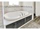 A bright and sunny soaking tub is accented by decoratively tiled walls at 3301 N 200 W, Franklin, IN 46131