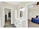 A modern bathroom includes a large vanity with an oval mirror and a glimpse into the main bedroom and walk-in closet at 3301 N 200 W, Franklin, IN 46131