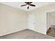 Carpeted bedroom featuring a ceiling fan, neutral walls, and a view into the hallway at 3301 N 200 W, Franklin, IN 46131